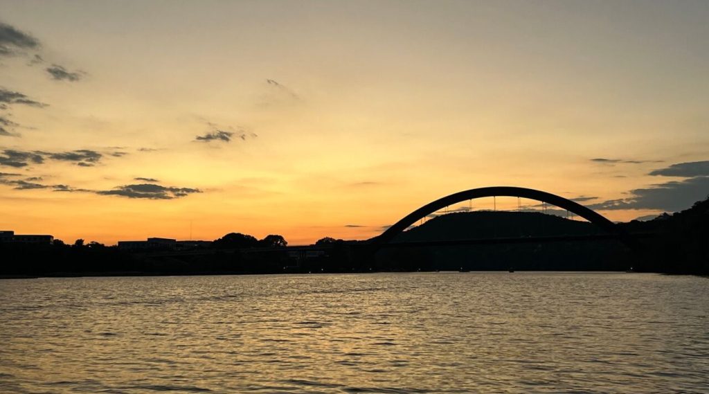 Sunset at Lake Austin with a bridge in the background